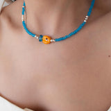 Blue Glass Beaded Fish Necklace With Orange Glass Fish Charm